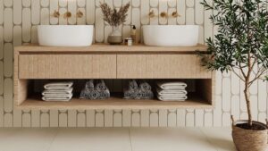 A bright bathroom with a double vanity unit, two sinks, and a houseplant for decoration.
