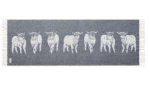 The image shows a Highland Cow Bed Runner. The distinctive shaggy coat and long horns of the cows are seen clearly. It's a charming and cosy addition to any home.