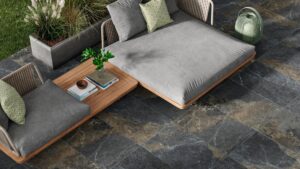 A luxurious outdoor living space featuring dark, multi-toned patio tiles.