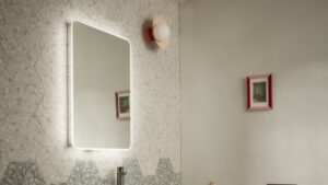 A rectangular mirror with a light glow around the border brings an ethereal feel to bathrooms